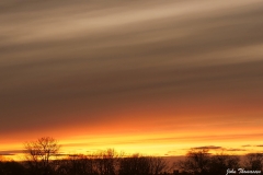 "uitgeveegde wolken" bij zonsondergang